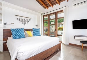 Elegant master bedroom at 9 Calle La Ronda, Las Catalinas with ocean views and modern design.