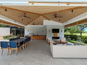 Covered terrace with BBQ, lounge seating, and outdoor dining area at Llama del Bosque 27, Reserva Conchal