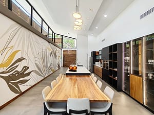 Elegant dining room with large table, open layout, and garden views at Llama del Bosque 27 in Reserva Conchal