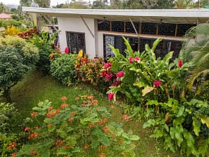 Lush tropical garden with native flora, vibrant greenery, and scenic pathways surrounding a luxury retreat near Arenal Volcano, Costa Rica.