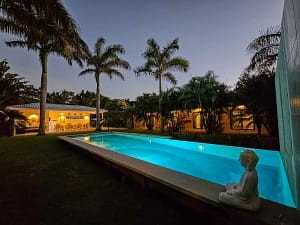 Night view of the illuminated pool at Seahorse Resort with waterfall, Costa Rica