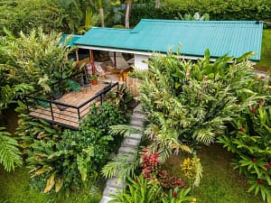 Aerial view of a luxury mountain retreat near Arenal Volcano, featuring two elegant homes, lush tropical gardens, and breathtaking rainforest surroundings.