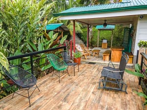 Spacious private balcony with breathtaking views of Arenal Volcano and the lush tropical rainforest, perfect for relaxation and outdoor dining.