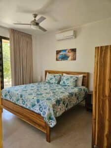 Spacious and elegantly designed bedroom in Villa Praga, Playa Grande, featuring a king-size bed, modern décor, and natural lighting.